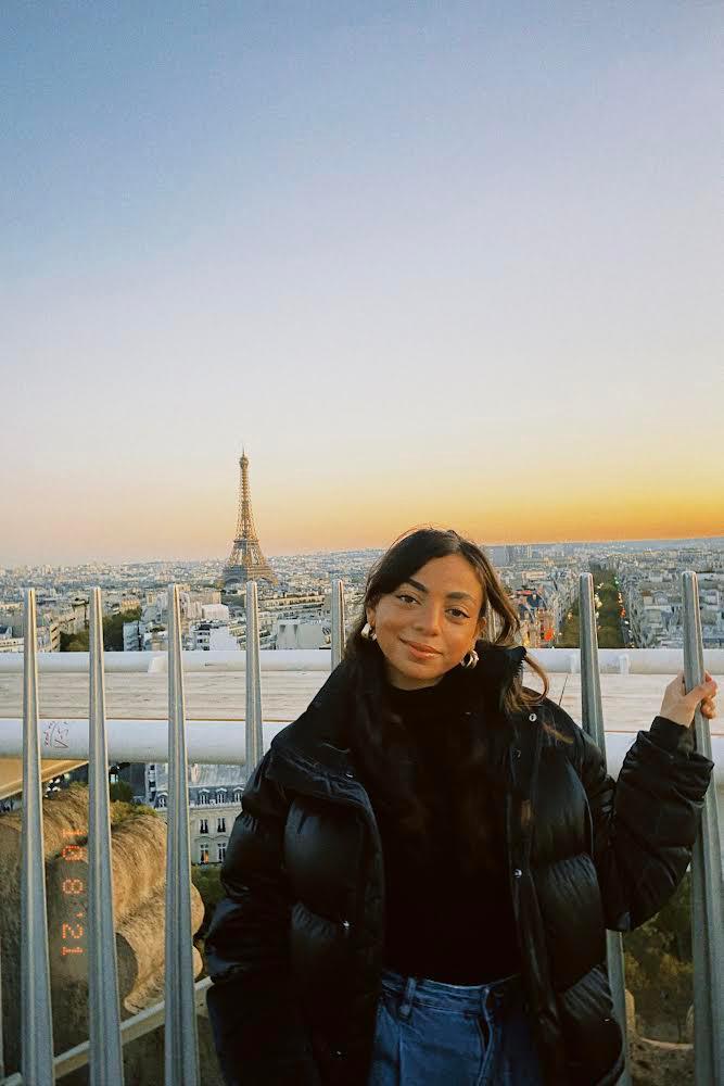 Farida Yehia poses in front of the Eiffel Tower in Paris.