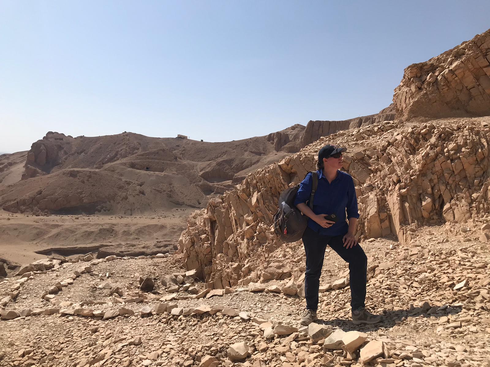 Marleen De Meyer stands in a rocky desert