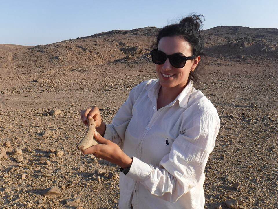 Meredith Brand holding a pottery fragment