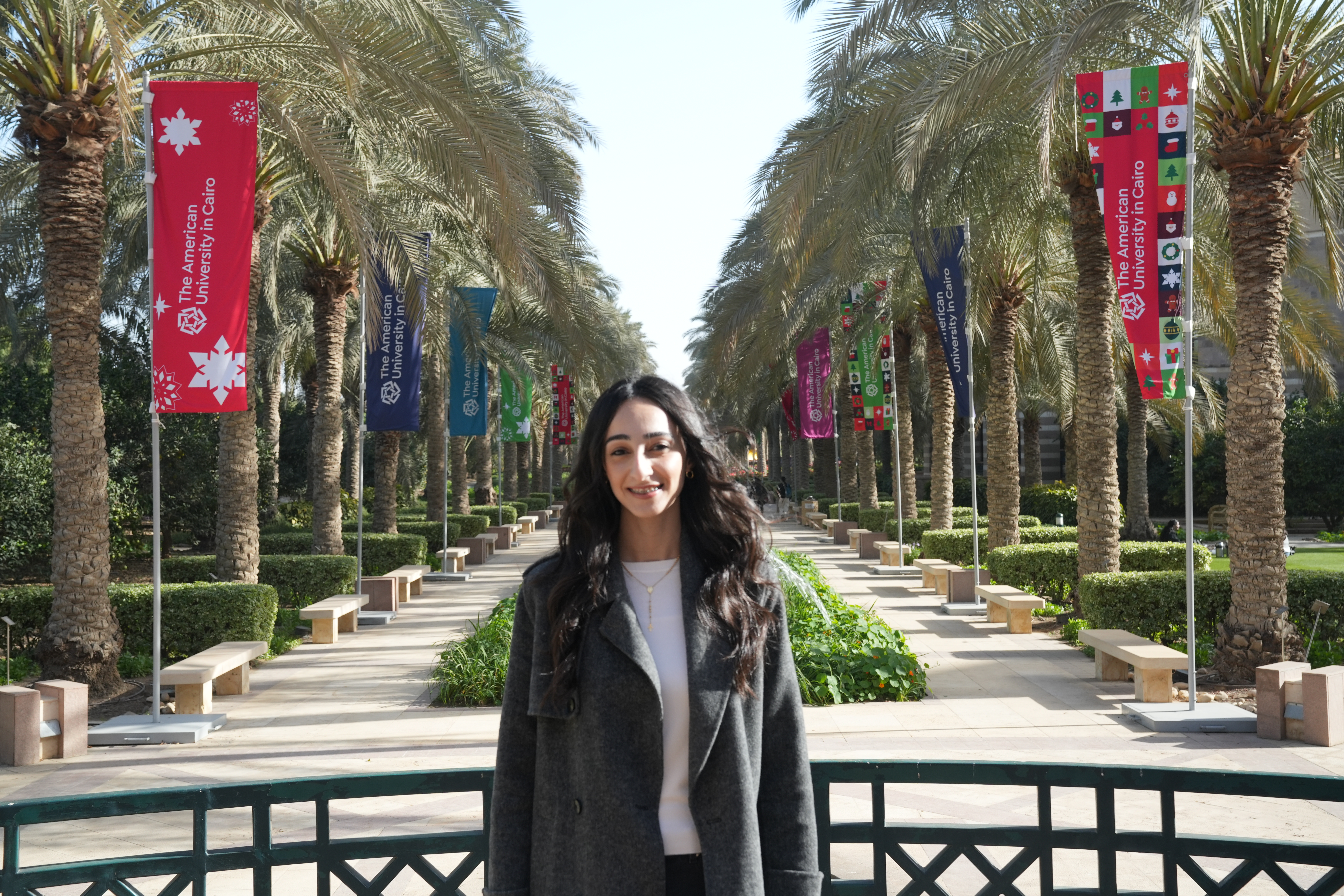 Monica Magdy stands in front of AUC banners