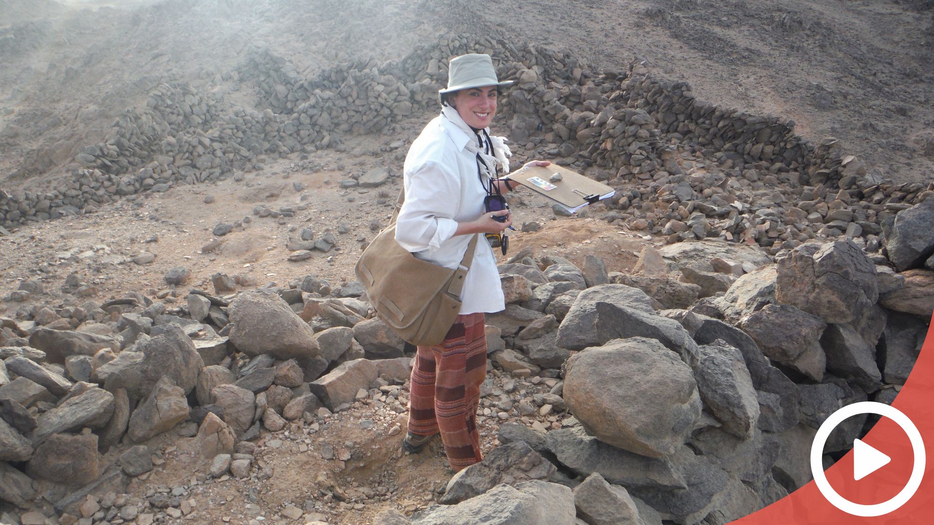 A video thumbnail: Meredith Brand smiling in ruins and holding a clipboard