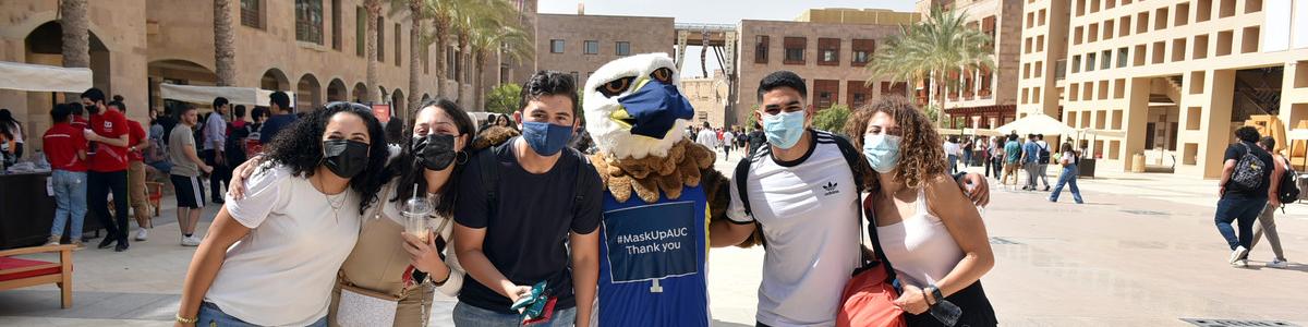 students with masked mascot
