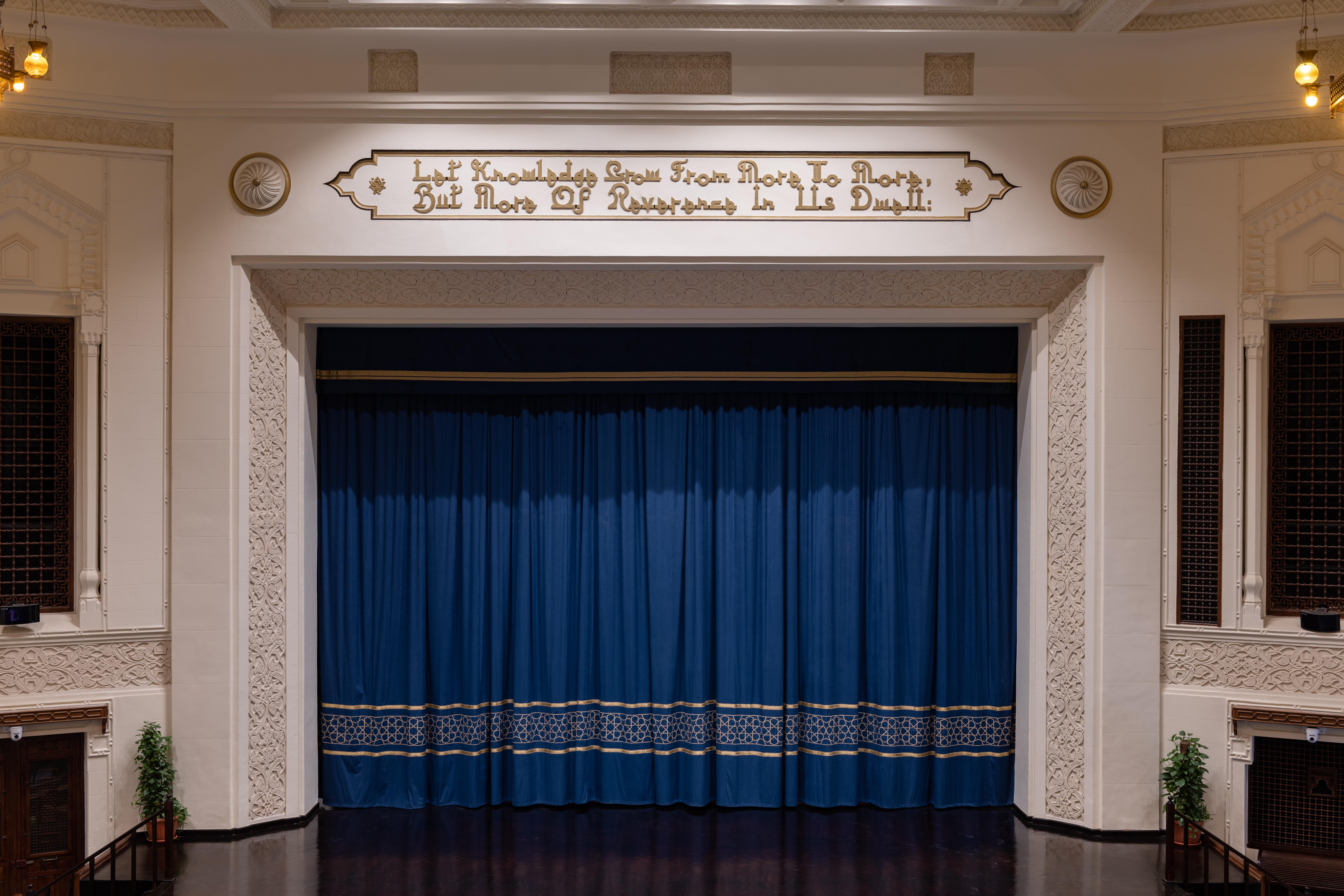 Ewart Hall stage with closed blue curtains