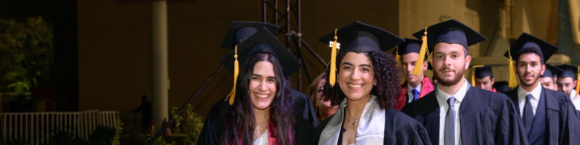 Smiling Students with cap and gown 
