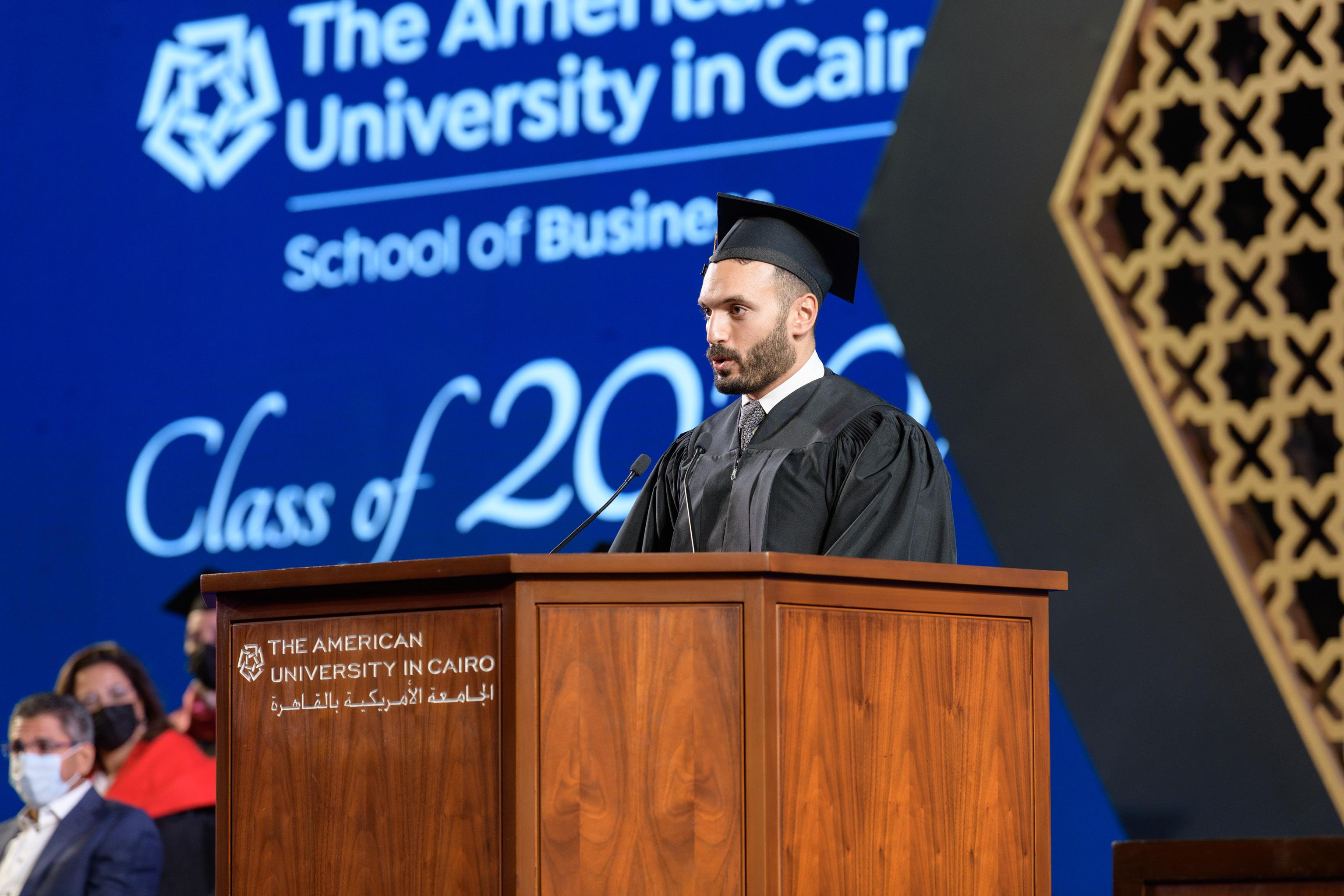 Graduating student standing on podium giving a speech