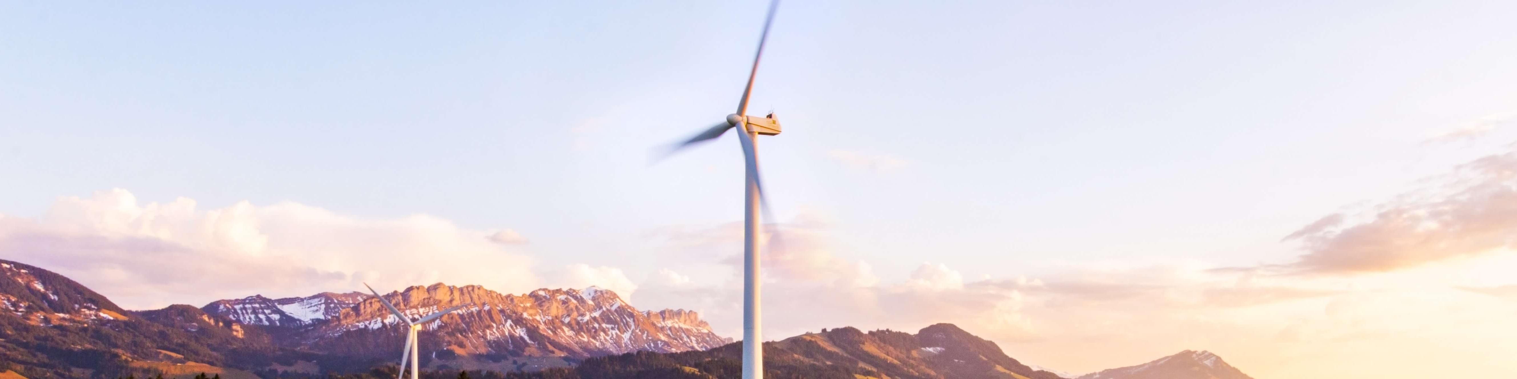 Windmills, mountains, trees, houses, greenery to represent energy transition for climate change
