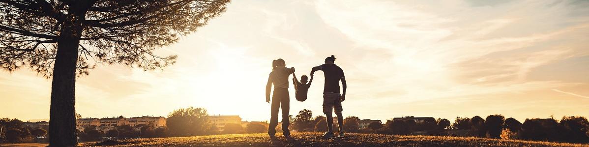 Silhouette of man, woman and child, and a tree representing public health in climate change