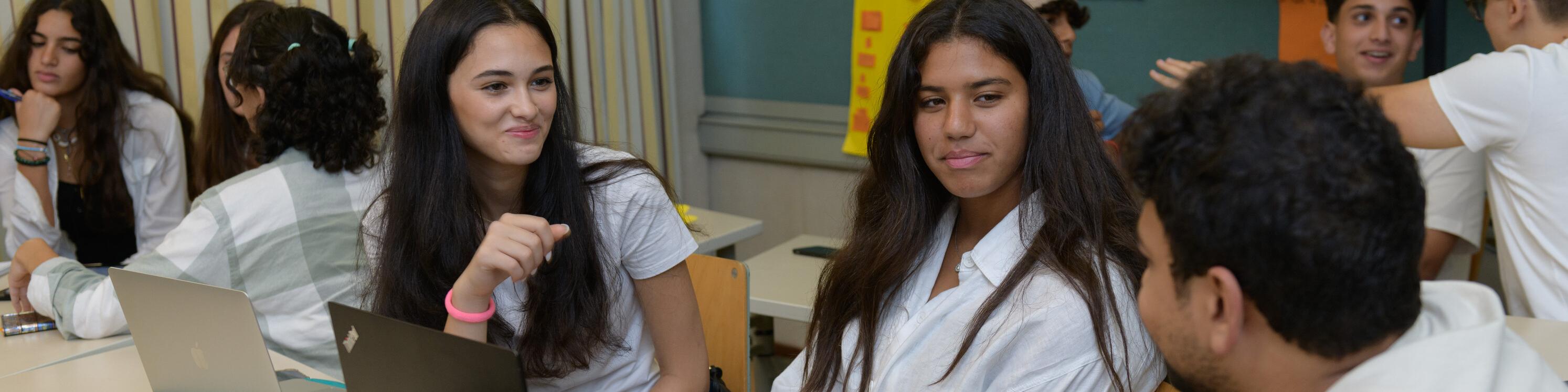 group of three students discussing a collaborative project