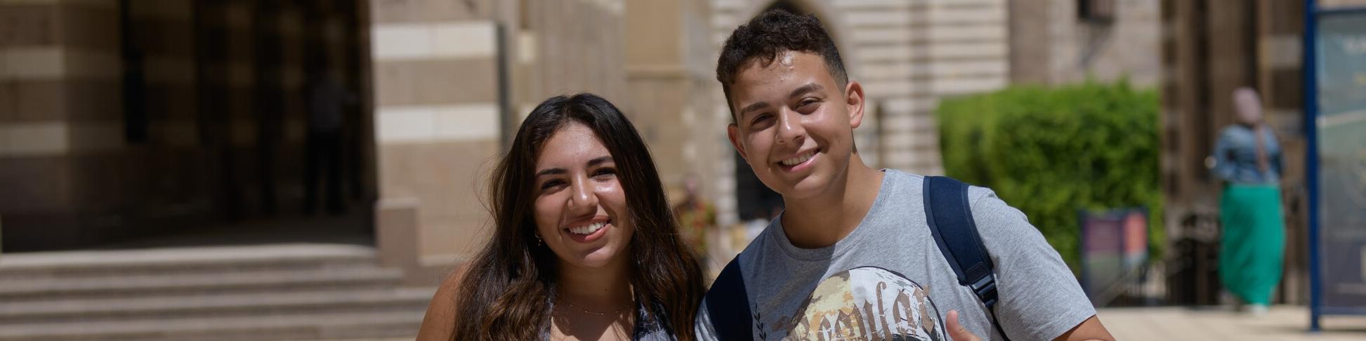 Boy and girl smiling on campus