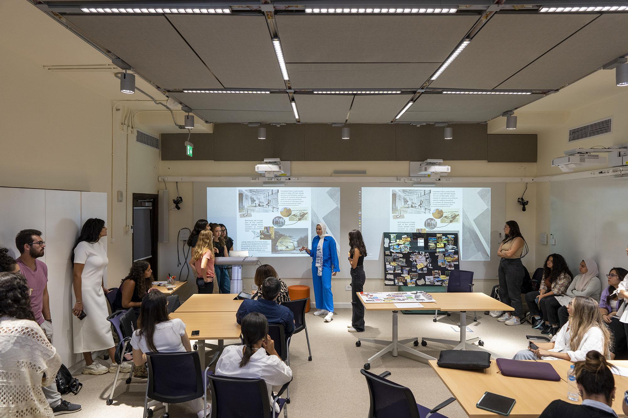 Professor explaining to students green and environmental diagrams