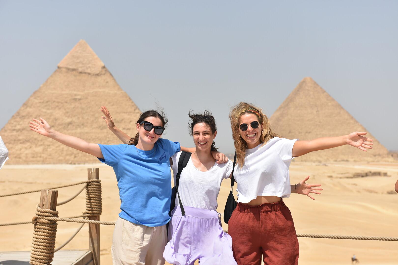 Three girls posing infront of the pyramids