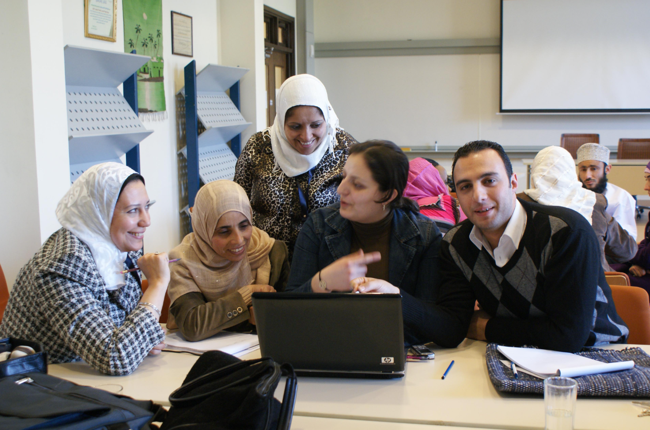 SRC Homepage image of group staff working together in a meeting room