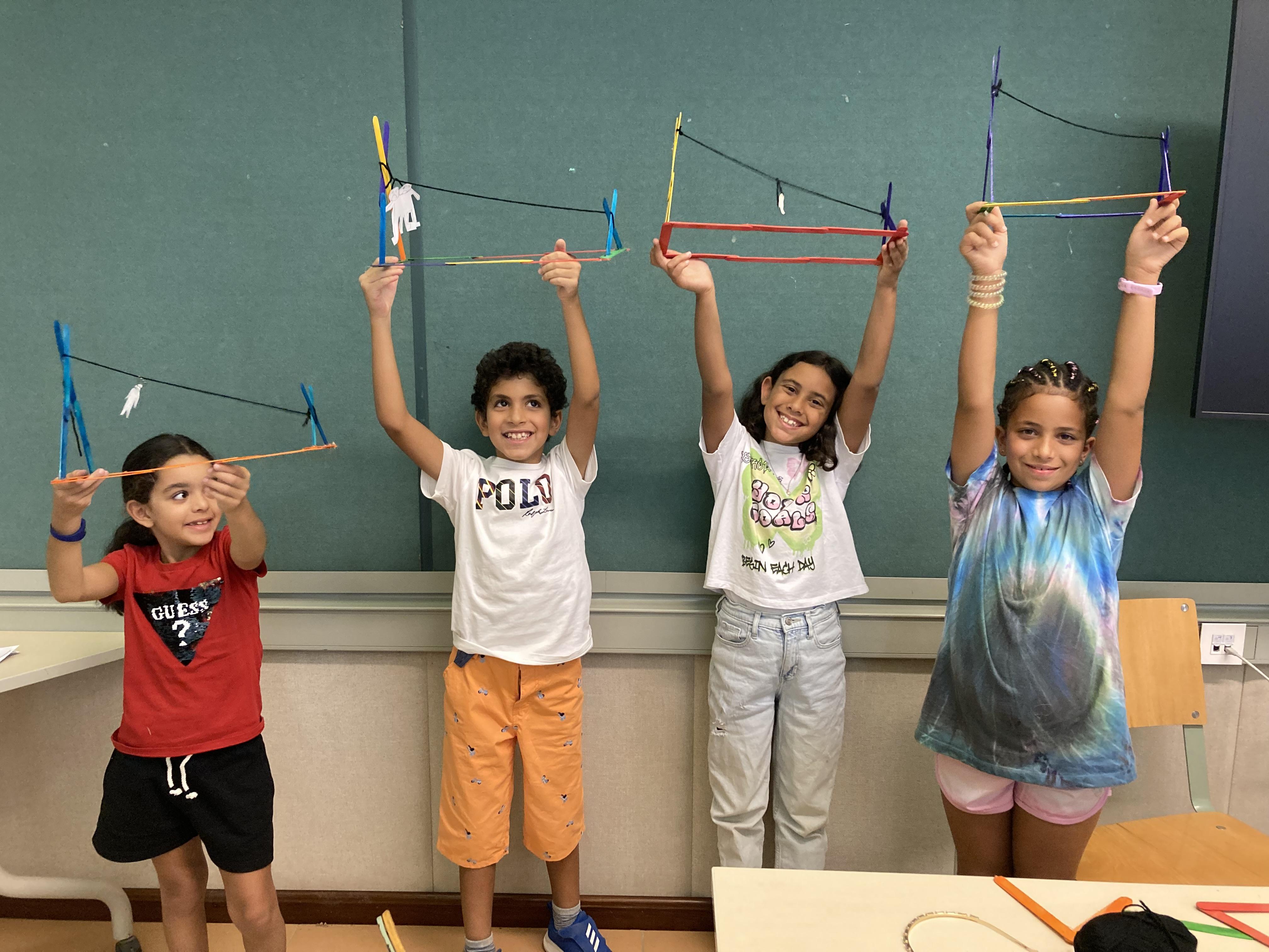 kids in class holding their built pieces