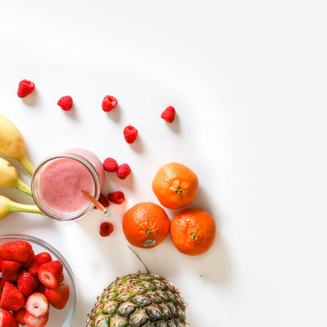 Picture with white background and fruits and a smoothie