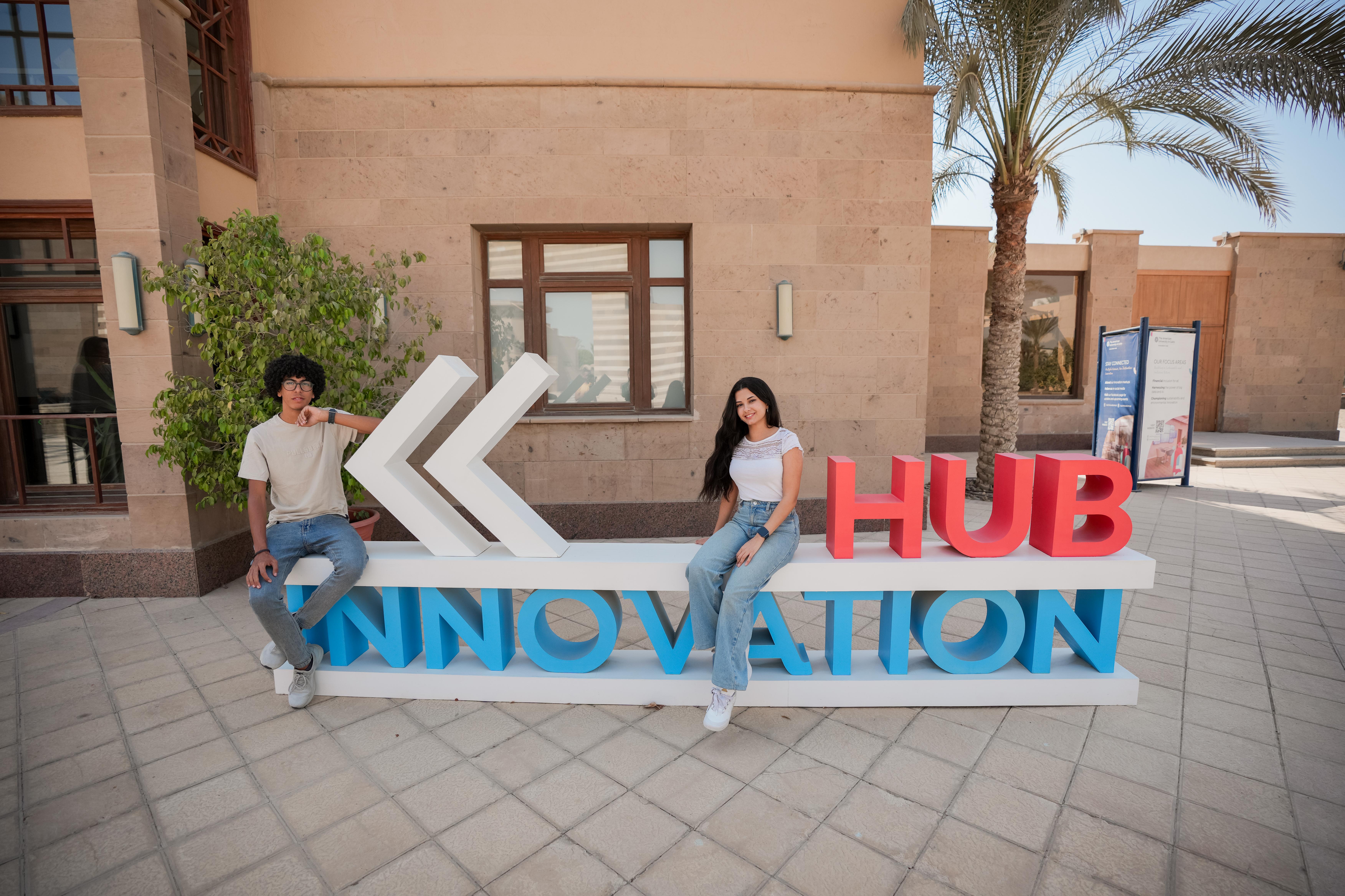 a girl and a boy sitting at the innovation hub