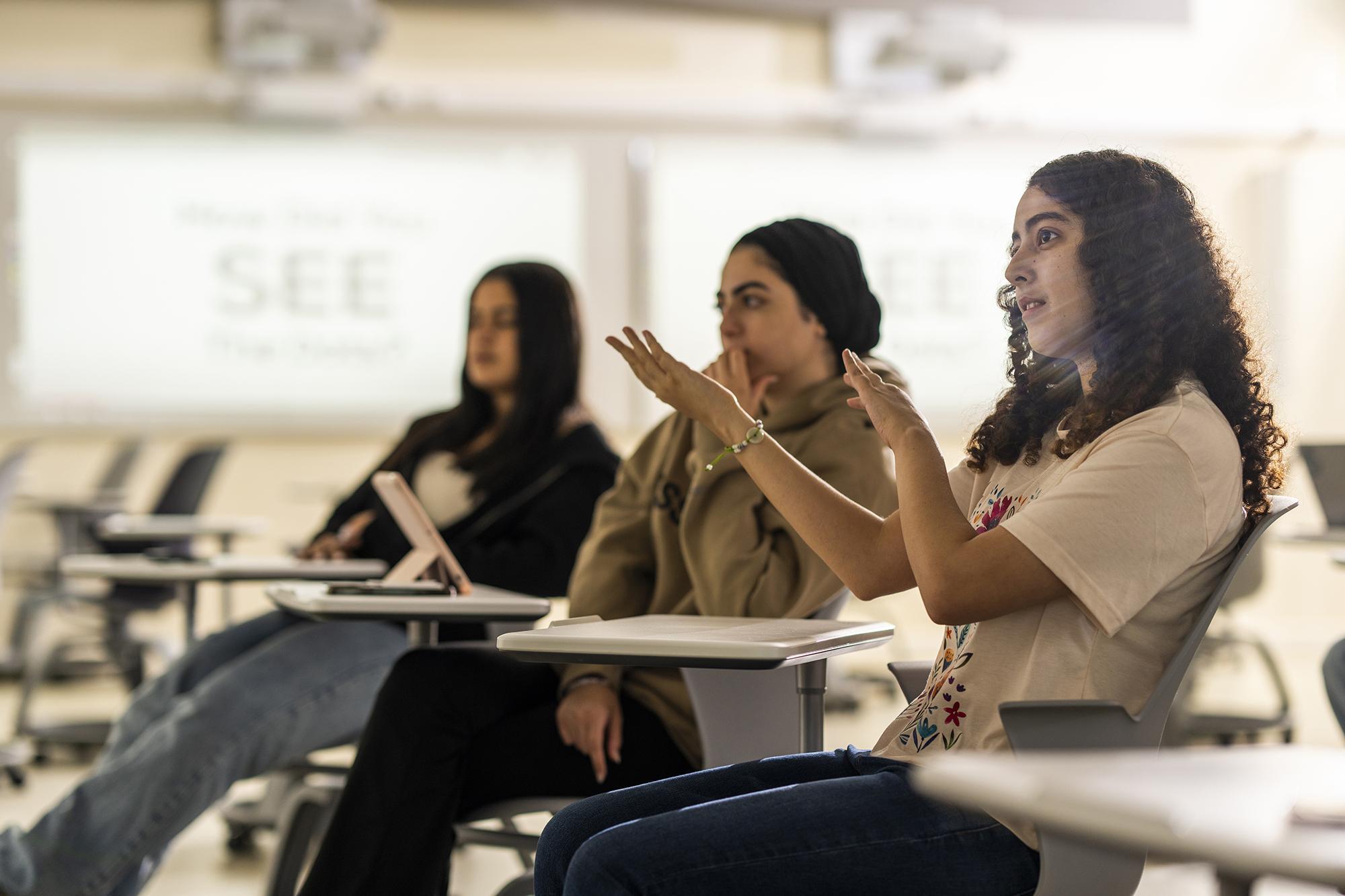 a female student engaging in a class discussion