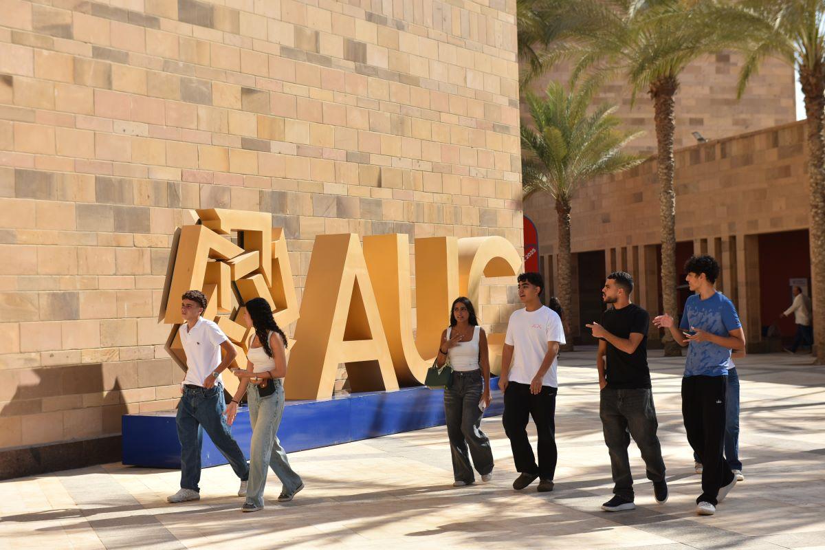 Some students walking around campus and talking together.