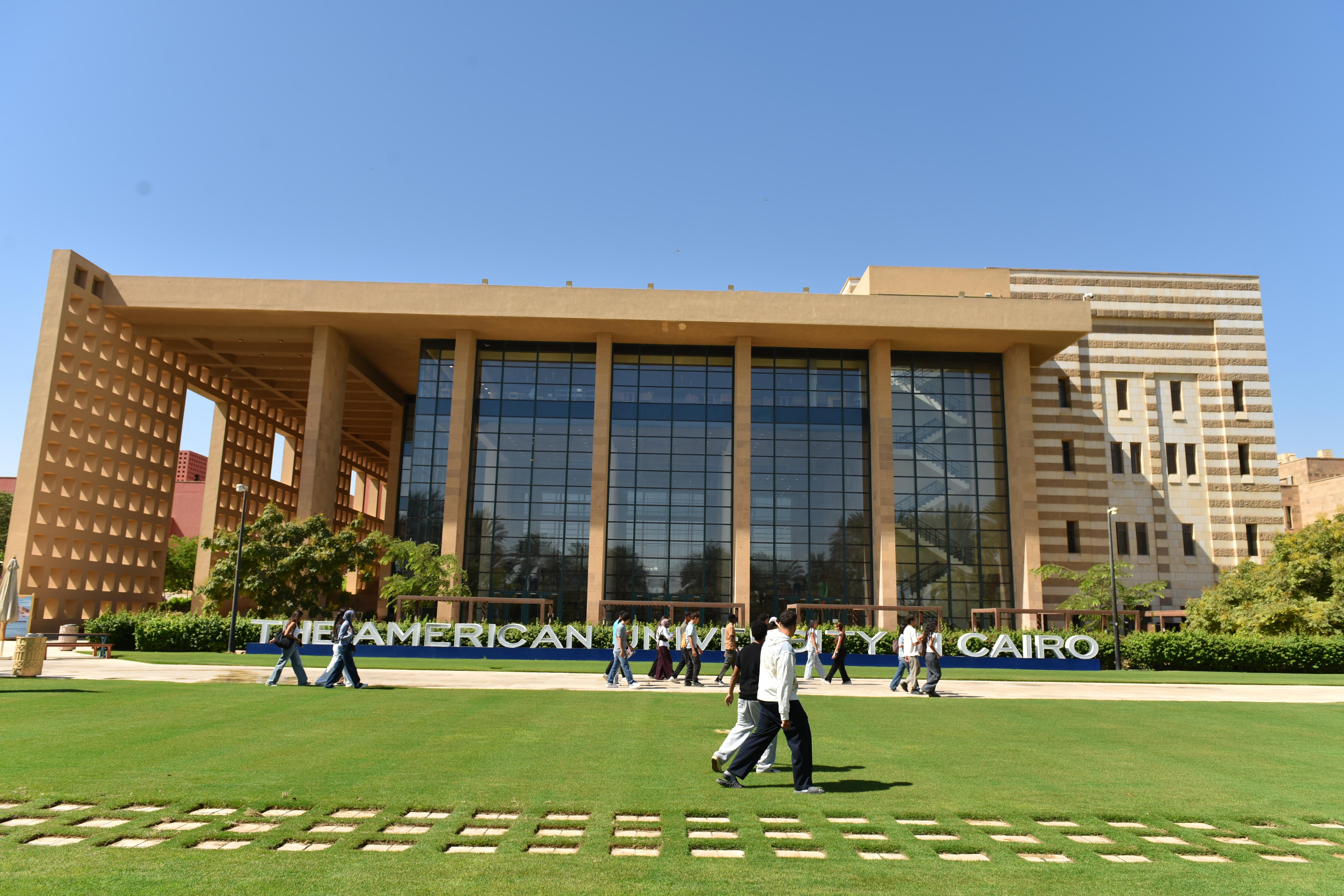 students walking in front of the AUC library gardens