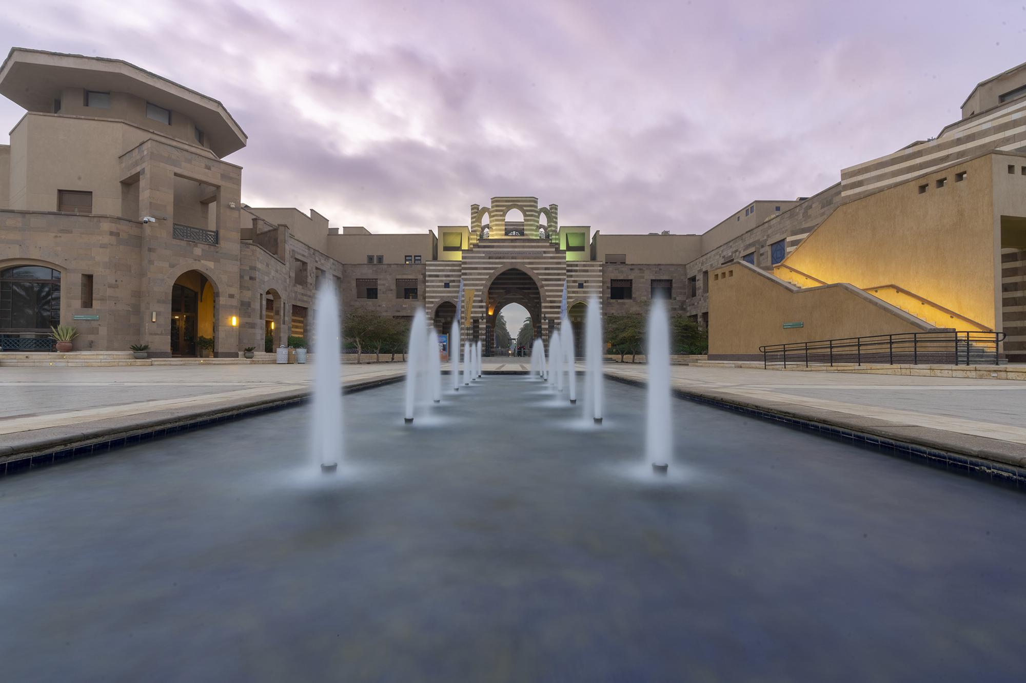 A big building with a fountain in front of it
