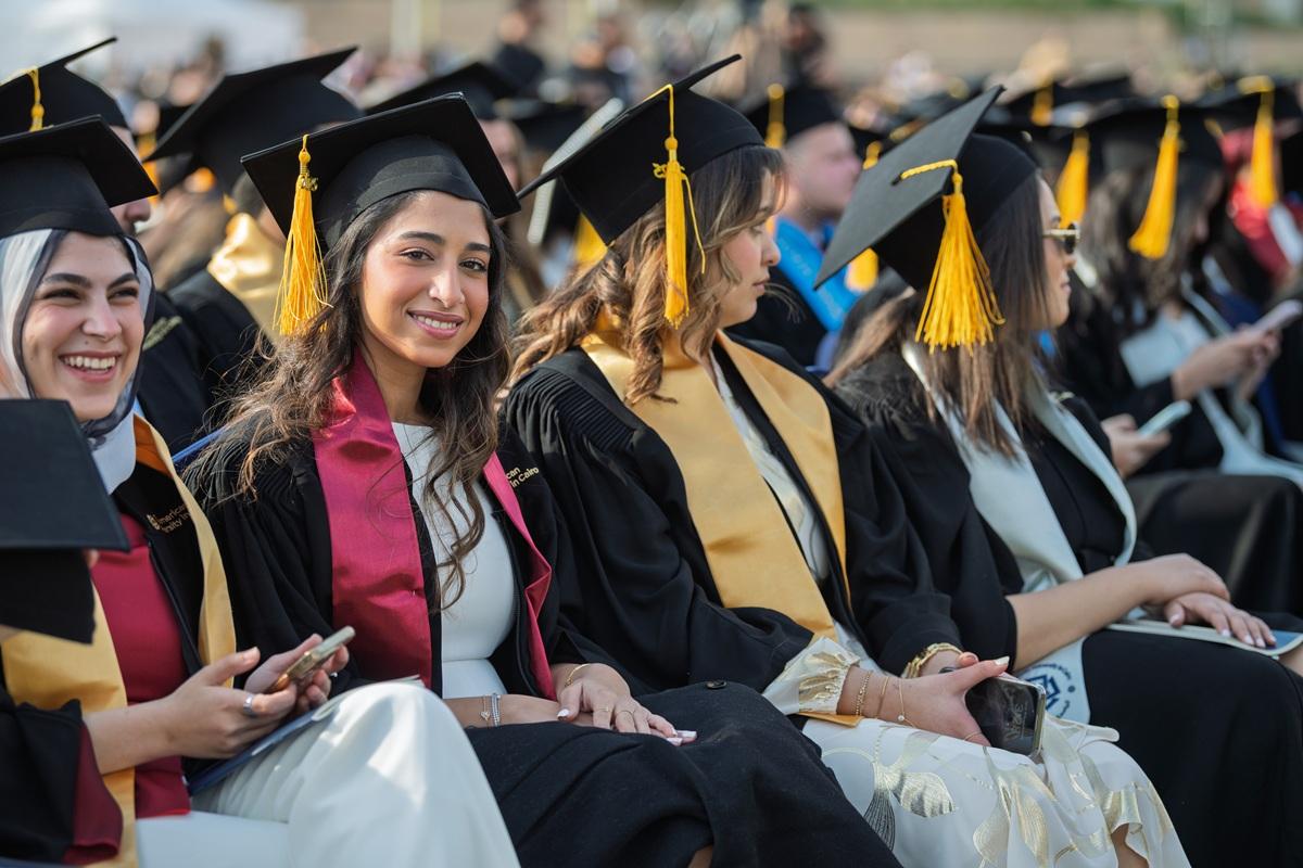 auc alumni female graduates smiling at the camera