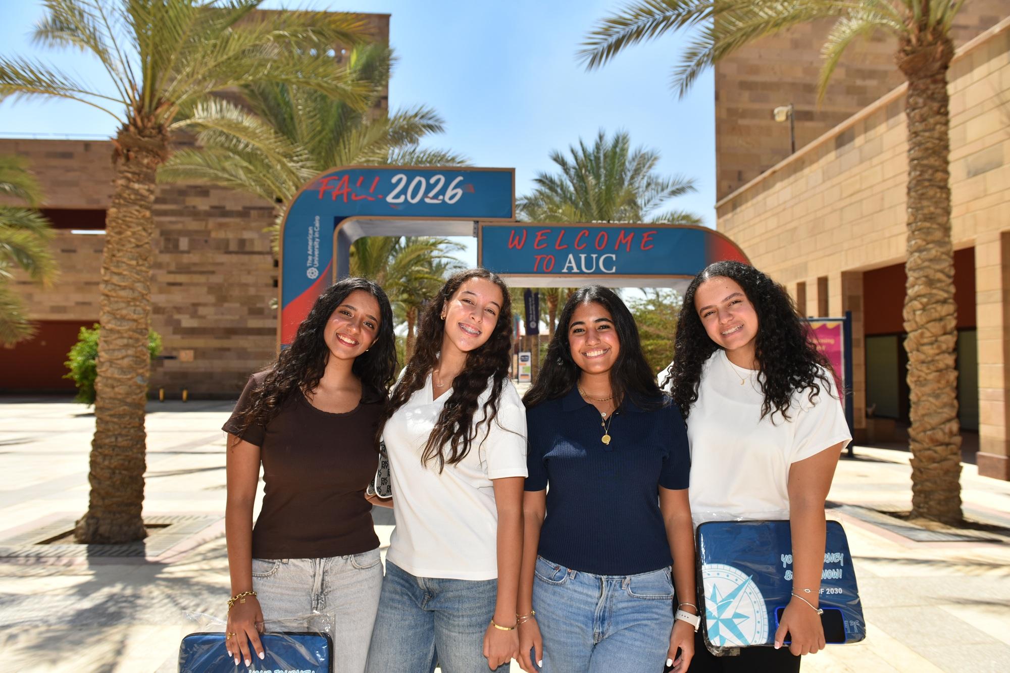 Four females are standing and smiling