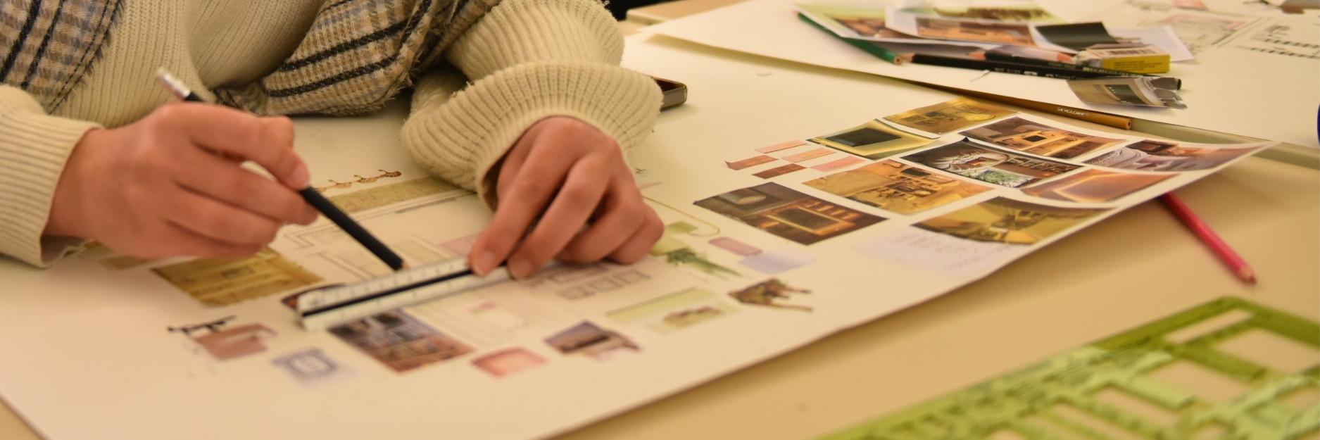 Student drawing on a sketch 