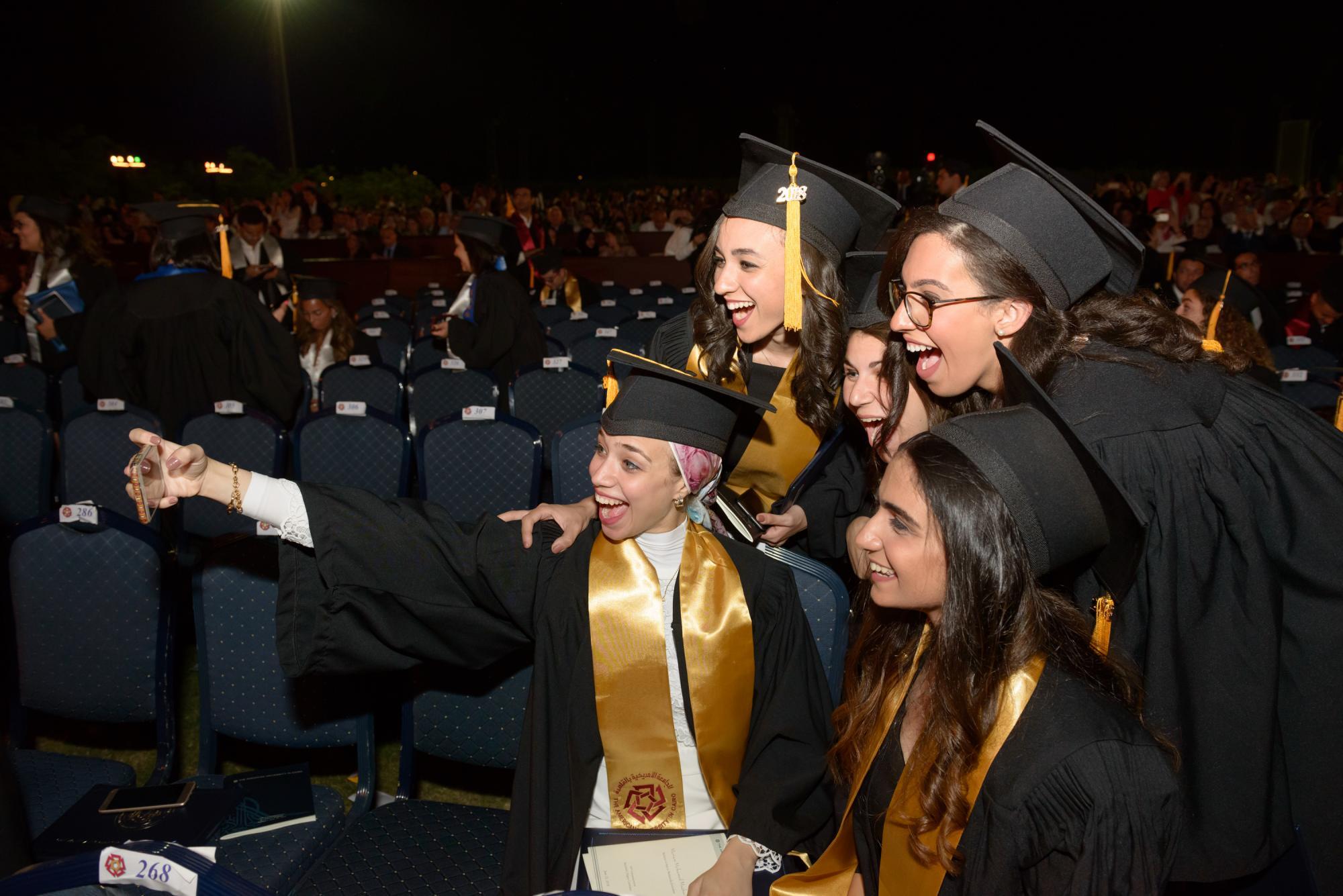 Undergraduate students take a selfie at commencements