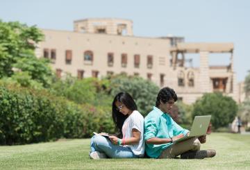 AUC students sitting in the campus garden.