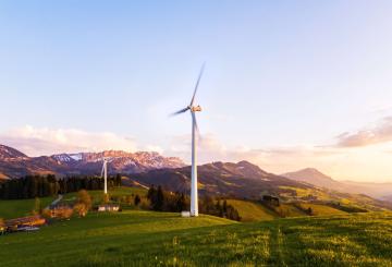 Windmills, mountains, trees, houses, greenery to represent energy transition for climate change