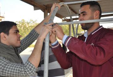 students adjusting pipes for water and irrigation