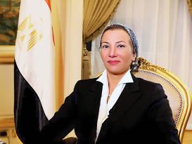 Woman sitting on a chair next to the Egyptian flag