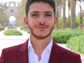 a boy wearing a white chemise and a red blazer