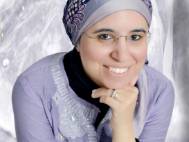 A veiled woman smiling and wearing glasses, text reads "Higher Education Influencers"