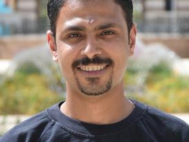 Headshot of a man smiling in outdoor setting