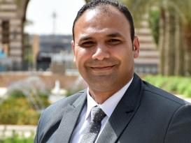 Man wearing a suit and tie smiling