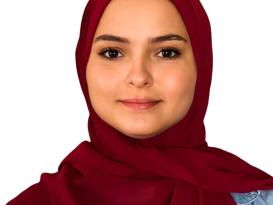 Headshot of a veiled girl smiling