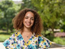 Headshot of a girl with curly hair smiling