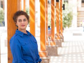 Woman in blue shirt smiling