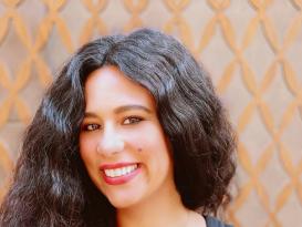 a girl with long black hair smiling