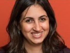 A headshot of a smiling woman