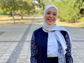 A veiled woman is smiling