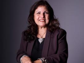 A woman is sitting and smiling
