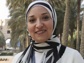 A veiled woman is smiling