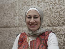 A woman is sitting and smiling