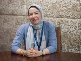 A woman is sitting and smiling