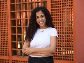 A woman standing and smiling