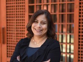 A woman standing and smiling