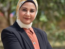 a headshot of a veiled woman wearing navy blue jacket