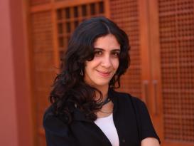 A woman standing and smiling