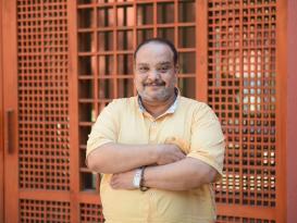 A man standing and smiling